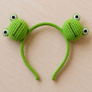 Handmade crochet frog headband featuring cute animal inspired handmade hair accessory