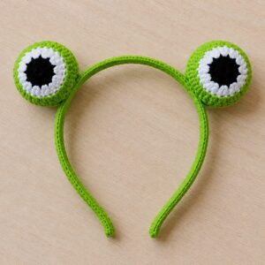 Handmade crochet monster eye headband featuring fun cartoon hair accessory