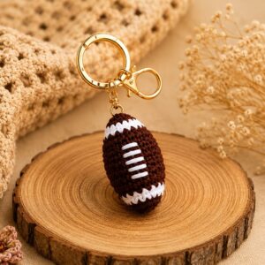 Handmade crochet football keychain with soft sports charm and durable metal clip