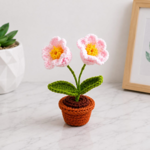 Handmade crochet flower pot decor with adorable pink blossom mini plant