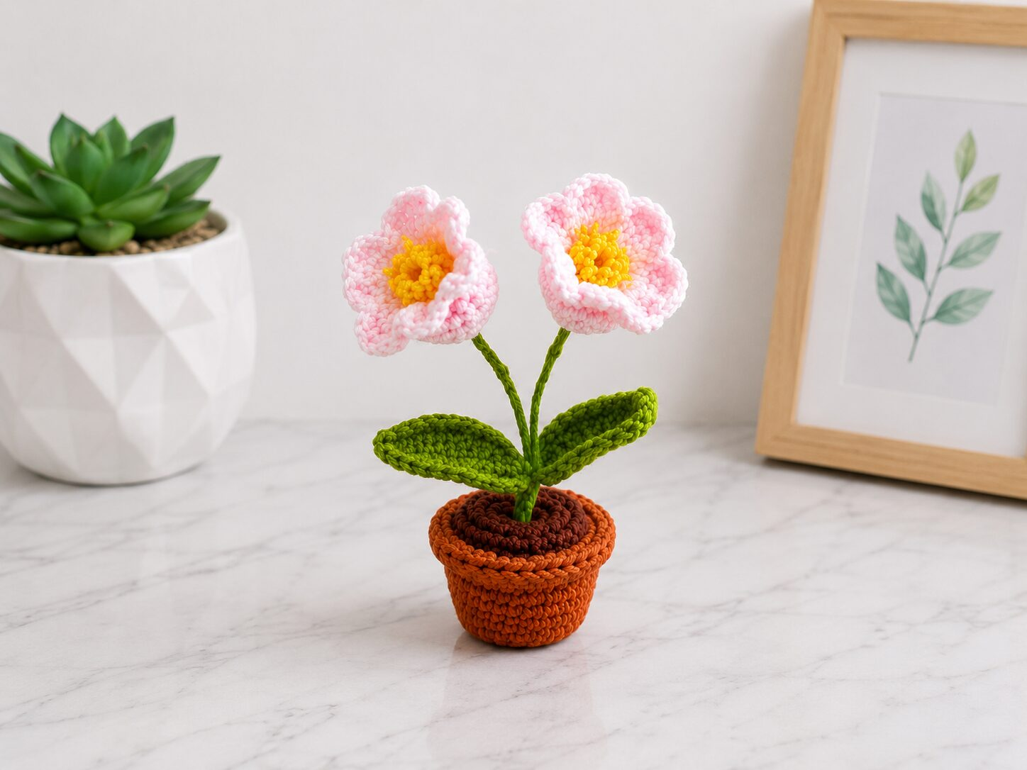 Handmade crochet flower pot decor with adorable pink blossom mini plant